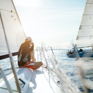 Young handsome man relaxing on his sailboat